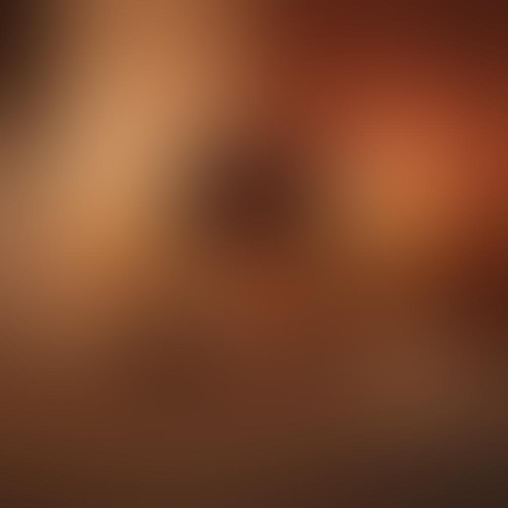 A sleek smartphone displaying a sensual scene from an erotic movie on its screen, surrounded by a softly lit room filled with plush velvet pillows and dimmed candles. In the background, a silhouetted couple is enjoying a cozy night in, enhancing the idea of mobile intimacy. The atmosphere is alluring and inviting, with a warm color palette that sets a romantic mood. super-realistic. vibrant colors. soft focus.